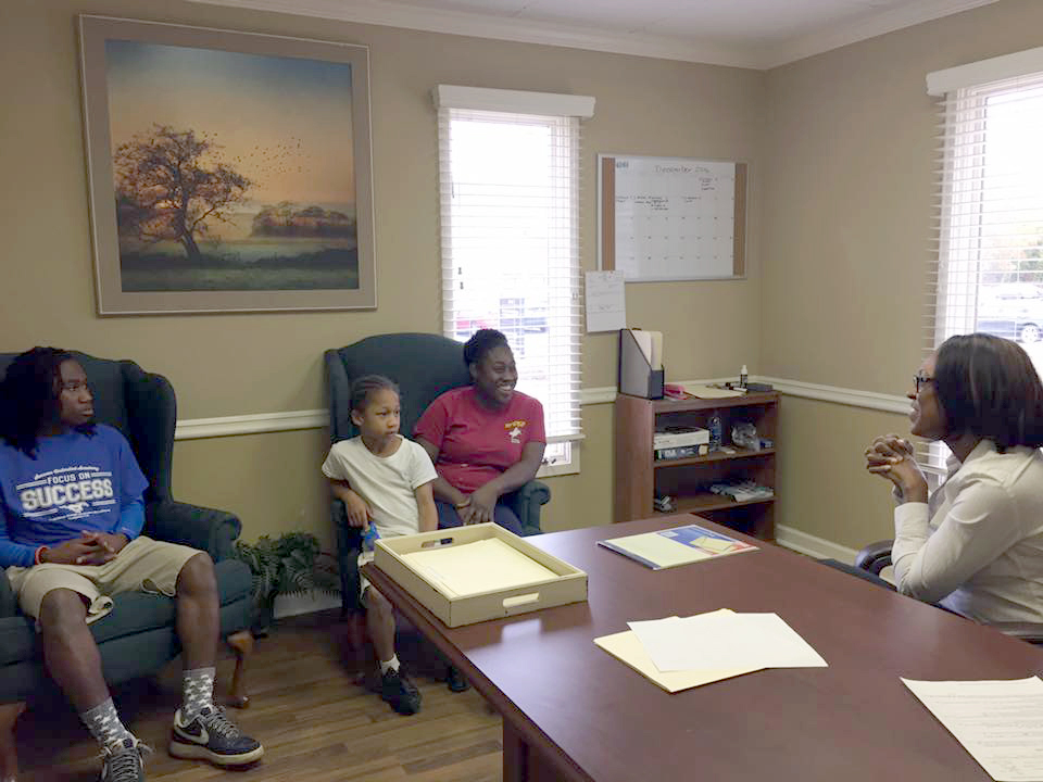 a group of people sitting at a table in a room